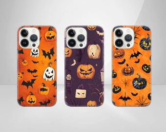 May include: Three smartphone cases featuring Halloween patterns. The left and right cases have orange backgrounds with black bats, spiderwebs, and jack-o'-lanterns. The center case has a dark purple background with pumpkins, bats, and lanterns.