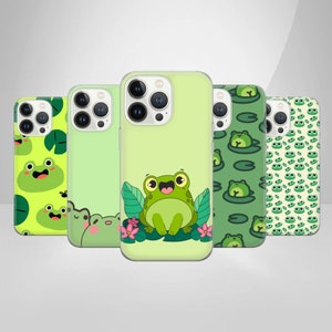 May include: Five different phone cases with frog designs. The cases are all green and feature different frog patterns, including a frog with a lily pad, a frog with a flower, and a frog with a polka dot pattern.