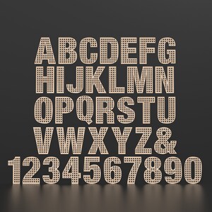 The full Alphabet of wooden letters with each letter having a rattan pattern cut out of the middle of it.