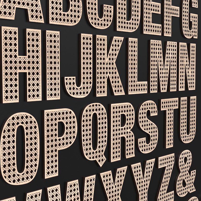 The full Alphabet of wooden letters with each letter having a rattan pattern cut out of the middle of it.