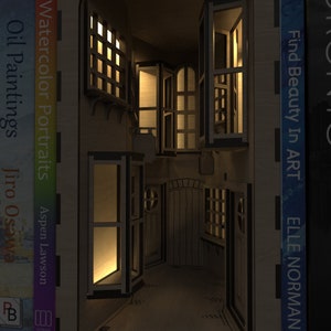 A magical scene of our Magic Alley Book Nook Kit illuminated at night, with light shining through the windows and doors, ideal for bookends and bookshelf décor, crafted from our downloadable SVG laser cutting files.