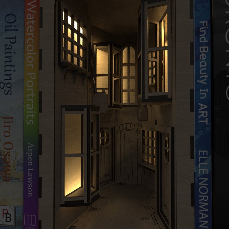 A magical scene of our Magic Alley Book Nook Kit illuminated at night, with light shining through the windows and doors, ideal for bookends and bookshelf décor, crafted from our downloadable SVG laser cutting files.