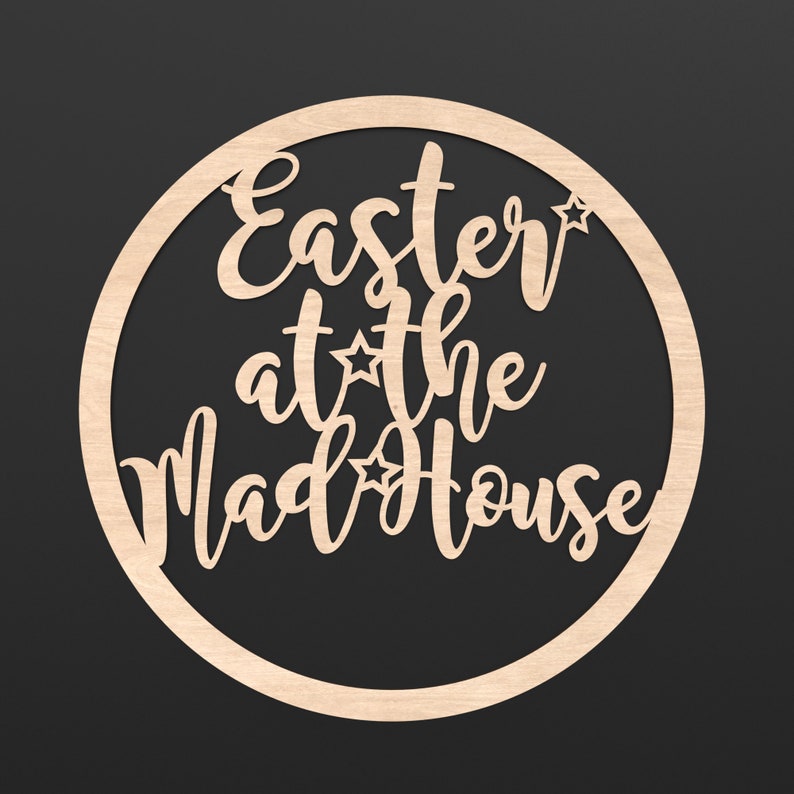 A wooden Circle Hoop with the wording Easter at the Madhouse cut out of the centre of it.