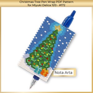 May include: A blue pen with a beaded Christmas tree pen wrap. The wrap features a green Christmas tree with colourful ornaments, a yellow star, and a blue snowy background. The text "Nota Arta" is visible.
