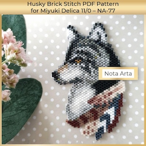 May include: A beaded husky dog design in shades of grey, black, white, brown, and blue. The design is made with small beads and features the text "Nota Arta". The image also includes the text "Husky Brick Stitch PDF Pattern for Miyuki Delica 11/0 - NA-77".