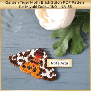 May include: A beaded Garden Tiger Moth brick stitch pattern in brown, white, orange, and black. The pattern is for Miyuki Delica 11/0 beads. The image includes the text "Nota Arta".