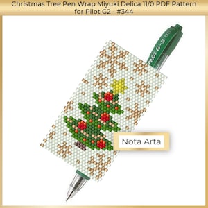 May include: A green pen with a white and gold beaded pen wrap featuring a Christmas tree design. The pen wrap is labeled "Nota Arta".