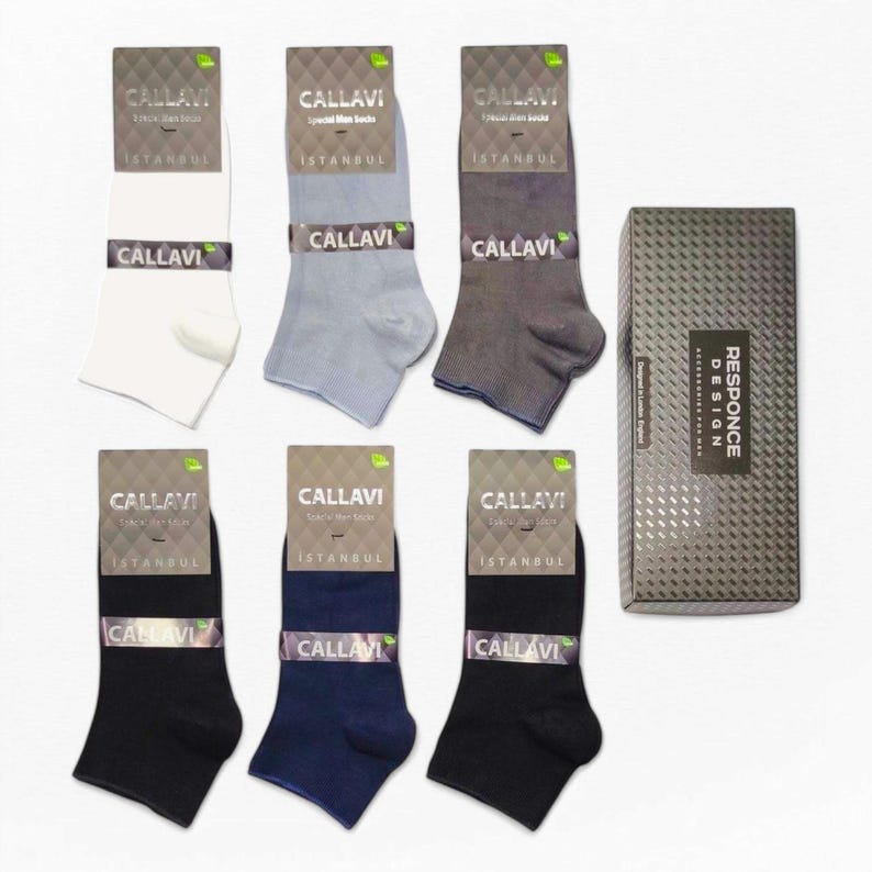 Six pairs of men's socks in white, light blue, gray, navy, blue, and black displayed with branded packaging.