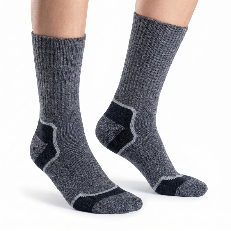 May include: A pair of mid-calf socks in a heathered charcoal gray knit fabric. The socks feature ribbed cuffs and solid black reinforced panels at the heel and toe areas, accented by thin light gray trim lines bordering the black sections.