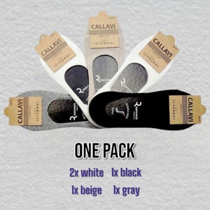 Five pairs of socks displayed: 2 white, 1 black, 1 beige, and 1 gray, all tagged  "ISTANBUL."