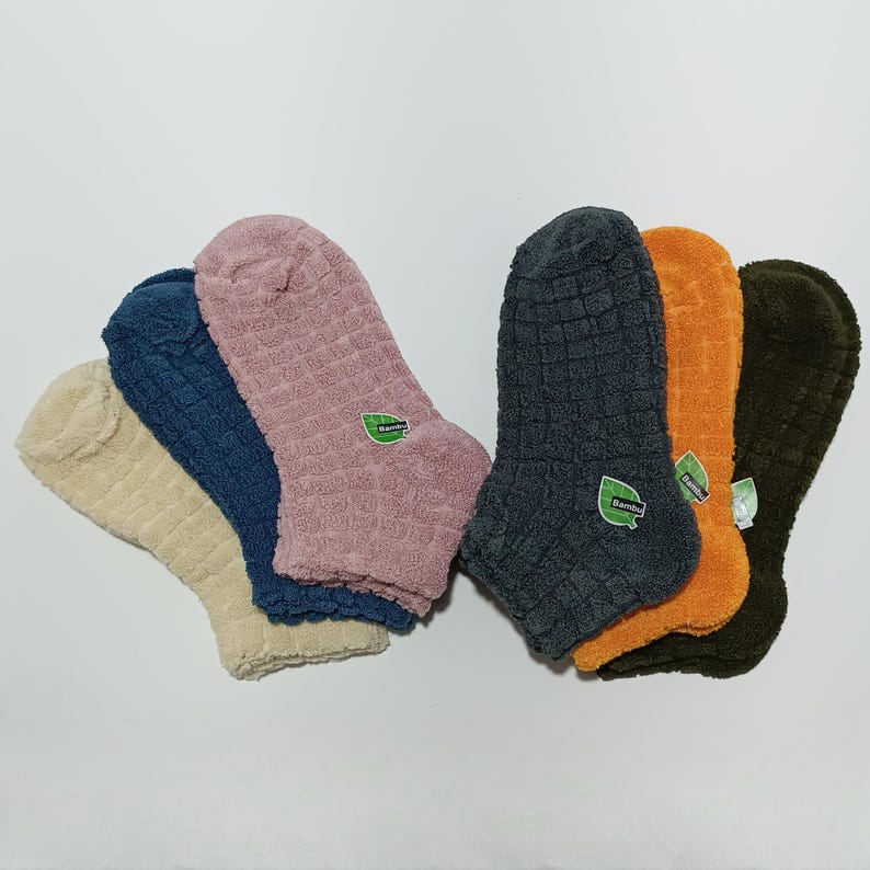 six pairs of colorful terrycloth socks with 'Bambu' labels displayed in a fan arrangement.