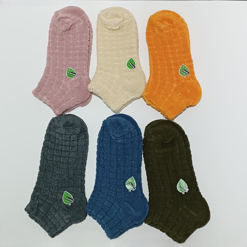 Six colorful winter ankle socks in two rows on a white background.