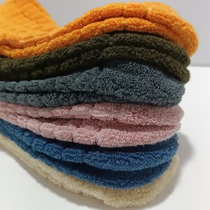 Stack of colorful ankle socks on a white background.