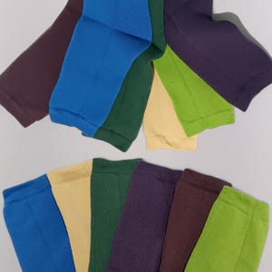 Assorted colorful socks arranged up and down only their super stretchy elastic parts visible on a white background.