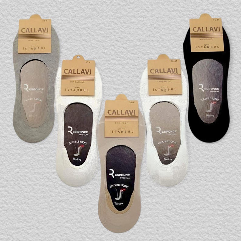 Five pairs of invisible socks in different colors (gray, beige, white, and black) displayed with branded tags on a textured background.