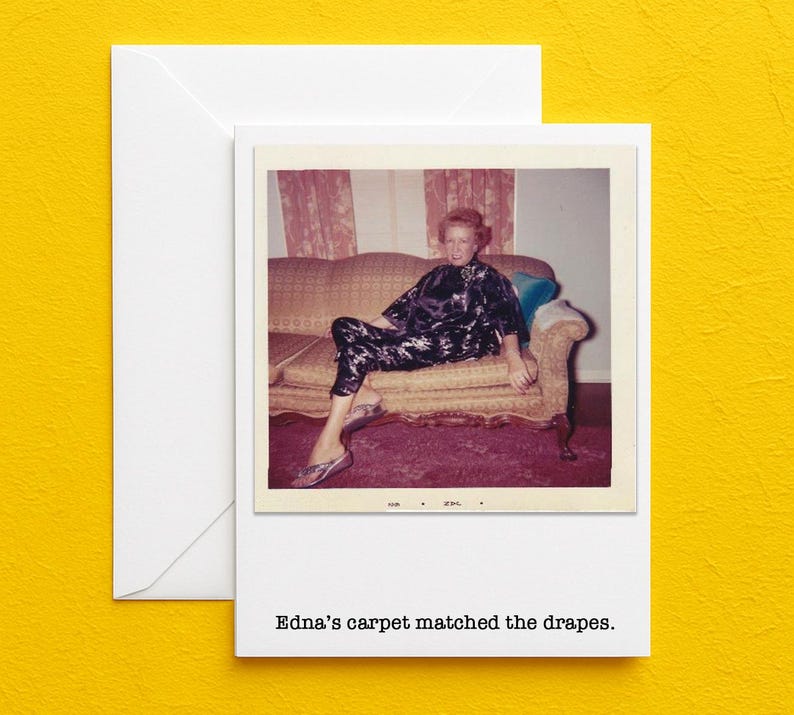 May include: A vintage photograph on a white card, featuring a woman in a floral print outfit seated on a sofa. The sofa is set against a backdrop of matching floral curtains. The text "Edna's carpet matched the drapes." is printed below the photo.