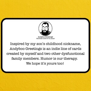May include: A white card with a black border and yellow background features the text "Andyboo Greetings" and a cartoon image of a man. The card's text describes the brand as an indie line of cards.