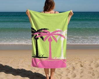 May include: A lime green beach towel with a pink and black palm tree design. The towel has a pink border and is held up on a beach with the ocean in the background. The palm trees are black, pink, and white.