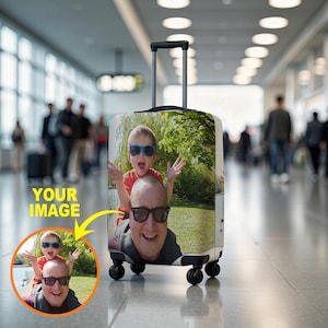 May include: A rolling suitcase with a custom photo print. The image on the suitcase features a man and a child wearing sunglasses. The suitcase has a retractable handle and four wheels, ideal for travel.