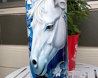 May include: A white horse head with blue and white floral design on a stainless steel tumbler.