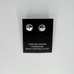 May include: A pair of sterling silver earrings with turquoise, red, and white inlay. The earrings are on a black card with the text "GENUINE INDIAN HANDMADE FROM STERLING SILVER".