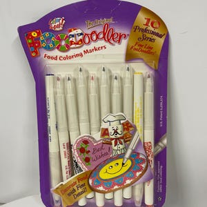 May include: A white ceramic mug with a black handle and the text "But First, Coffee" in a bold, black font. The mug is sitting on a wooden surface. The mug is approximately 4 inches tall.