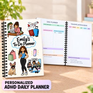 May include: A spiral-bound daily planner with a white cover featuring cartoon illustrations of a person working, traveling, shopping, and exercising with a dog. The text reads Emily's To-Do Planner. The open pages show sections for daily focus, tasks, and notes.