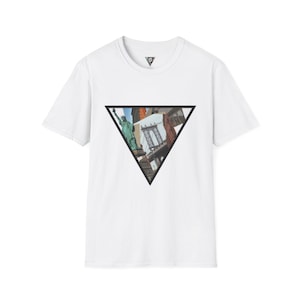 May include: White t-shirt featuring a black triangle graphic with a collage of New York City landmarks, including the Statue of Liberty and a bridge. The shirt has a crew neck and short sleeves. A small triangle logo is on the upper chest.