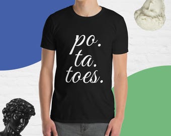 May include: A black t-shirt with white text that reads "po. ta. toes."