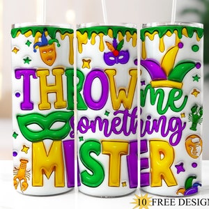 May include: Three white tumblers with a Mardi Gras theme. The tumblers feature a purple, green and gold design with the text "Throw me something Mister".