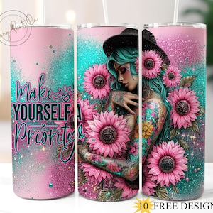 Może przedstawiać: Zestaw trzech kubków ze stali nierdzewnej, każdy o pojemności około 590 ml, z różowo-turkusowym brokatowym wzorem. Jeden ma napis "Make Yourself A Priority". Pozostałe przedstawiają kobietę z turkusowymi włosami i tatuażami, otoczoną różowymi słonecznikami.