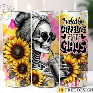 May include: A white tumbler with a colorful design featuring a skull with sunglasses, sunflowers, and the text "Fueled by Caffeine and Chaos".