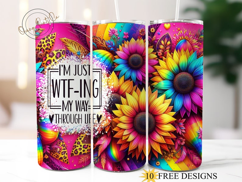 May include: A stainless steel tumbler with a pink background and a rainbow design featuring sunflowers. The tumbler has the text "I'm just WTF-ing my way through life" printed on it.