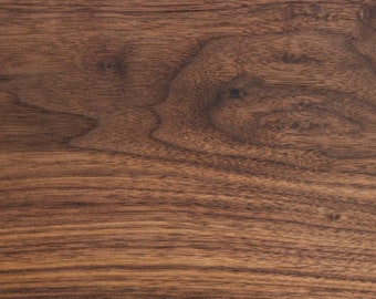 May include: Close-up of a dark brown wood grain surface with a natural wood pattern.