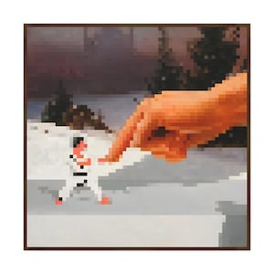 May include: Pixelated artwork depicting a figure in a white karate uniform being touched by a large orange hand. The background shows a snowy landscape with trees and a dark sky. The artwork is framed in a brown border.