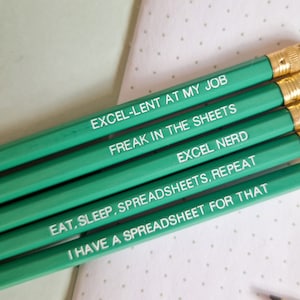 May include: Five green pencils with white text. The pencils have the following text: "Excel-lent at my job", "Freak in the sheets", "Excel nerd", "Eat, sleep, spreadsheets, repeat", and "I have a spreadsheet for that".