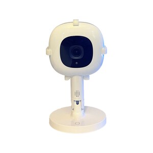May include: A white baby monitor with a round camera lens and a stand. The camera is mounted on a swivel base.