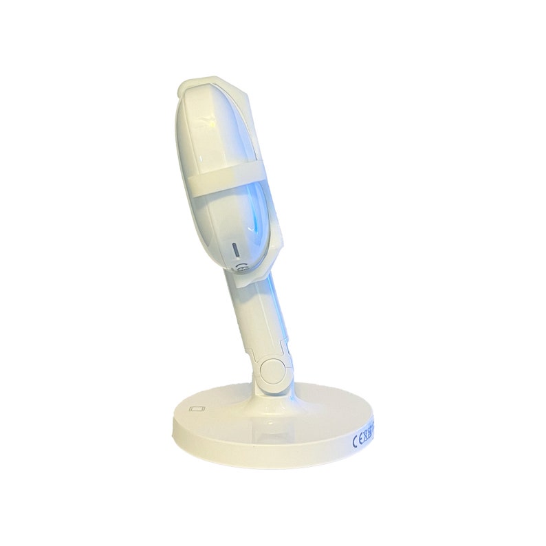 May include: White UV light sanitizer with a round base and a flexible arm. The sanitizer has a white strap and a blue light.