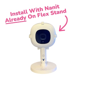 May include: White baby monitor with a black camera lens mounted on a white flexible stand. The text "Install With Nanit Already On Flex Stand" is written in pink above the monitor.