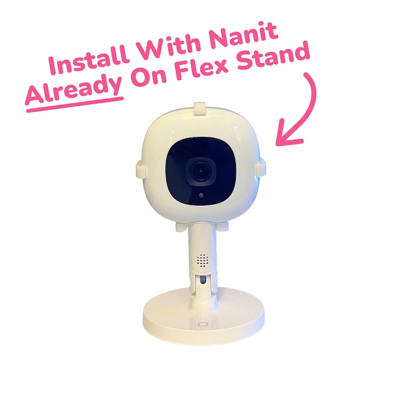May include: White baby monitor with a black camera lens mounted on a white flexible stand. The text "Install With Nanit Already On Flex Stand" is written in pink above the monitor.