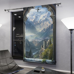 May include: A tapestry featuring a stone archway with a view of a mountain range and a castle in the distance. The sky is blue with white clouds and there are birds flying in the air.