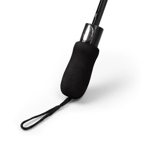 May include: Close-up of a black umbrella handle with a textured, ergonomic grip. The handle features a wrist strap and a silver-colored button. The umbrella's shaft is visible, extending upwards from the handle.