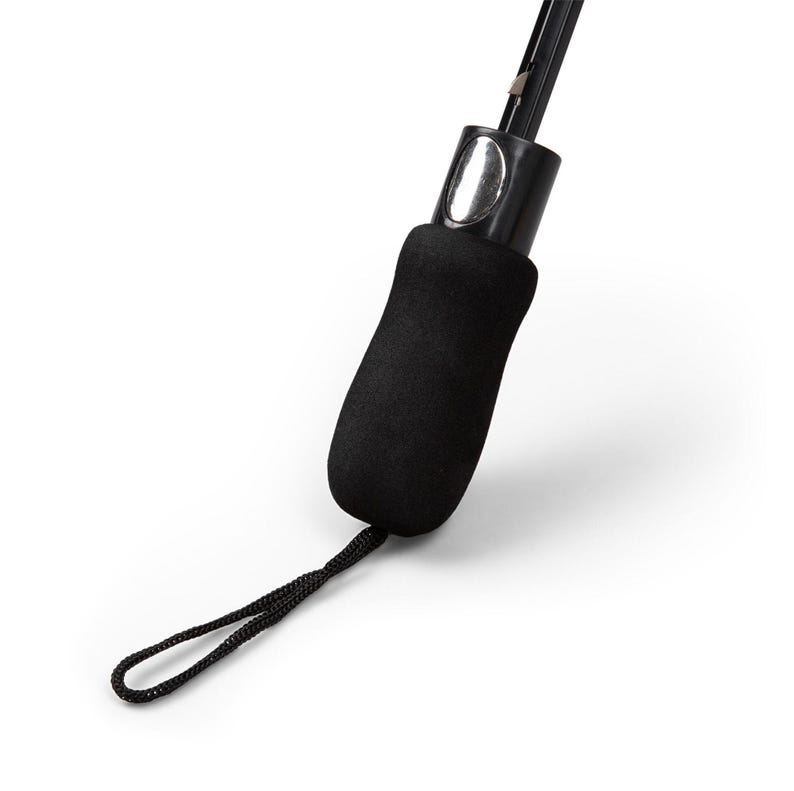 May include: Close-up of a black umbrella handle with a textured, ergonomic grip. The handle features a wrist strap and a silver-colored button. The umbrella's shaft is visible, extending upwards from the handle.