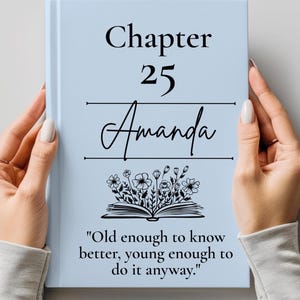 May include: A light blue hardcover book featuring the text "Chapter 25 Amanda" in black font, centered above a black line illustration of an open book with flowers growing out of it, followed by the quote "Old enough to know better, young enough to do it anyway."