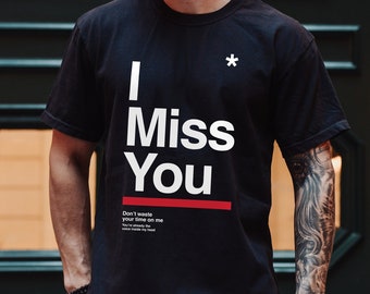 May include: Black t-shirt with white text that reads "I Miss You" and a red line underneath. The text "Don't waste your time on me" is printed in smaller white text below the red line.