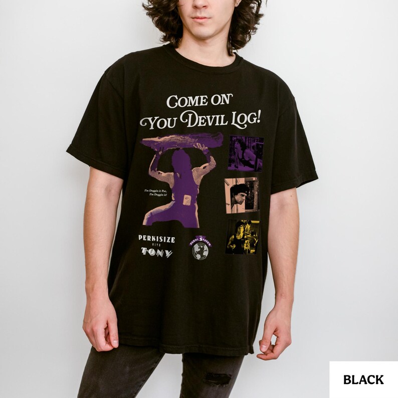 May include: Black t-shirt with the text "Come On You Devil Log!" and a graphic of a person lifting a log. The shirt also features the text "Perkisize with Tony" and several small images. The shirt is black.