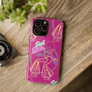 May include: A pink phone case with a neon pink and green illustration of a woman in a disco outfit. The text "Soul Sista" is written in neon pink letters.