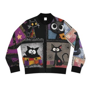 May include: Black bomber jacket featuring a patchwork design with cartoon black cats. The jacket has a black zipper and cuffs. The cats have large eyes and are set against a background of purple, gray, and orange squares. The sleeves have a purple and black pattern.