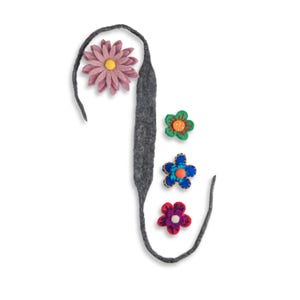 May include: A gray felt ribbon shaped like the letter J with four felt flowers attached to it. The flowers are pink, green, blue, and red.