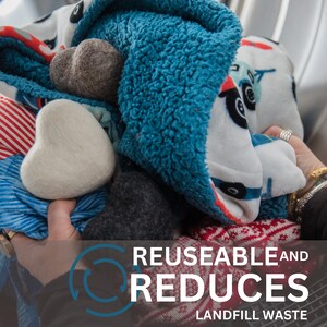 May include: A pile of colorful blankets and fabric scraps with the text "REUSABLE AND REDUCES LANDFILL WASTE" on a brown background.
